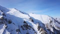 Mountain peaks covered with snow. Blue sky with light white clouds. Royalty Free Stock Photo