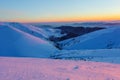 Mountain peaks covered with snow and ice, on which falls blue shadow, against the blue sky. Frosty day, gorgeous wintry scene.