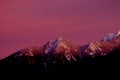 Mountain peaks covered in snow during sunset - pink sky Royalty Free Stock Photo