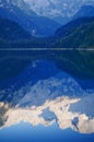 Mountain peaks reflecting in lake