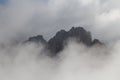 Mountain peaks seeing through dense fog, Dolomites, Italian Alps Royalty Free Stock Photo