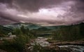 Mountain peaks and storm clouds and road in mountain, Norway Royalty Free Stock Photo