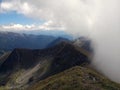Mountain peeks surrounded by clouds Royalty Free Stock Photo