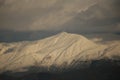 mountain pick with snow on top clouds ice winter background in mitsikeli mountain grreece Royalty Free Stock Photo