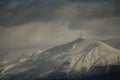 mountain pick with snow on top clouds ice winter background in mitsikeli mountain grreece Royalty Free Stock Photo