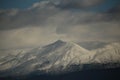 mountain pick with snow on top clouds ice winter background in mitsikeli mountain grreece Royalty Free Stock Photo