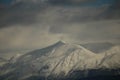 mountain pick with snow on top clouds ice winter background in mitsikeli mountain grreece Royalty Free Stock Photo