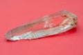 Mountain quartz crystal on a pink background. Royalty Free Stock Photo