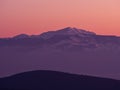 Mountain range covered in snow in dusk colors, Greece