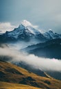 a mountain range with a few clouds in the foreground and a few trees in the background with a blue sky Royalty Free Stock Photo