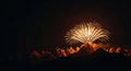 Golden Fireworks Exploding Over Majestic Mountains at Night Royalty Free Stock Photo