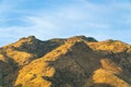 Mountain range in hills of arizona in the sonora desert in late afternoon early morning sunlight with blue cloudy sky Royalty Free Stock Photo