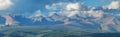 Mountain range, panoramic view. Peaks in the clouds, evening Royalty Free Stock Photo