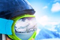 Reflection of the winter mountain landscape in a ski mask. Shallow depth of field. Royalty Free Stock Photo