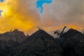 Mountain range snow peaks under orange sunset clouds Royalty Free Stock Photo