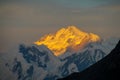 Mountain range snow peaks under orange sunset clouds Royalty Free Stock Photo