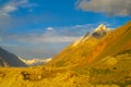 Mountain range snow peaks under orange sunset light Royalty Free Stock Photo