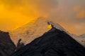 Mountain range snow peaks under orange sunset light Royalty Free Stock Photo