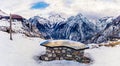 Mountain range and valley below with map on stone table and wooden cross Royalty Free Stock Photo