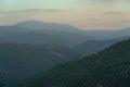 Mountain range with valley, mist and small white house Royalty Free Stock Photo