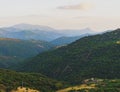 Mountain range with valley, mist and small white house and electric poles