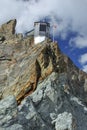 Mountain refuge perched on rock spine Royalty Free Stock Photo