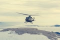 Mountain rescue helicopter landing to pick up wounded. Royalty Free Stock Photo