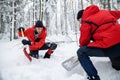 Mountain rescue service on operation outdoors in winter in forest, digging snow with shovels. Royalty Free Stock Photo