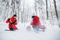 Mountain rescue service on operation outdoors in winter in forest, digging snow with shovels. Royalty Free Stock Photo