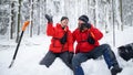 Mountain rescue service on operation outdoors in winter in forest, giving figh five. Royalty Free Stock Photo