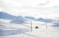 Mountain rescue workers driving a snowmobile in the winter mountains.