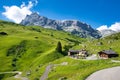 Mountain restaurant in front of the large rock face of the Sulzfluh, Sulzfluh via ferrata, St. Antoenien in Graubuenden Royalty Free Stock Photo