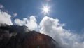 Mountain ridge clouds and sun