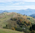 Mountain ridge with dirt road and private farm on the slope of it