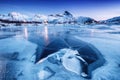 Mountain ridge and ice on the frozen lake surface. Natural landscape on the Lofoten islands, Norway. Royalty Free Stock Photo