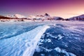 Mountain ridge and ice on the frozen lake surface. Natural landscape on the Lofoten islands, Norway. Royalty Free Stock Photo