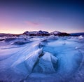 Mountain ridge and reflection on the frozen lake surface. Natural landscape on the Lofoten islands, Norway. Royalty Free Stock Photo