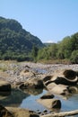 Mountain river in Adygea, rocky beach, large boulders, summer day in the mountains,