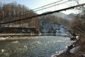 Suspension bridge over mountain river in Adygea