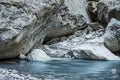 Mountain river among boulders. The river bed in the canyon. Royalty Free Stock Photo