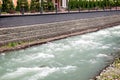 Mountain river flowing along the embankment.