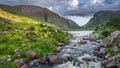 Mountain river flowing from Black Lake in Gap of Dunloe. Green hills at sunset in Black Valley Royalty Free Stock Photo