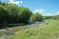 Mountain river flows in forest under bias Royalty Free Stock Photo