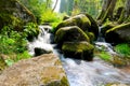 Mountain river with green mossy stones and small waterfall. Captured in Sumava National Park in Czech Republic. Royalty Free Stock Photo