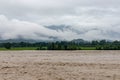 A mountain river raging in a flash flood during heavy rains in the summer