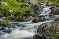 Mountain river among stones on spring day with silk effect. Jets crash against rocks and foam Royalty Free Stock Photo