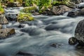 Mountain river among stones on spring day with silk effect. Jets crash against rocks and foam Royalty Free Stock Photo