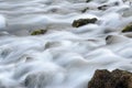 Mountain river stream in autumn, long exposure. Crystal clear water flowing over rocks and green moss. Water slowly flows across t Royalty Free Stock Photo