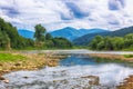 Mountain river stream of water in the rocks with majestic stormy Royalty Free Stock Photo