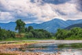 Mountain river stream of water in the rocks with majestic stormy Royalty Free Stock Photo